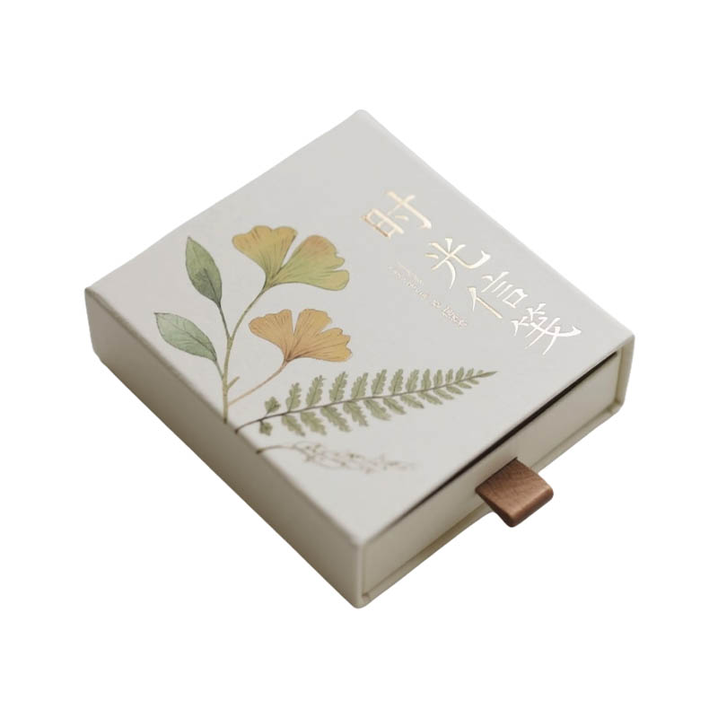 How exactly does the pull-out box embody both the ritual of opening and practical aesthetics within its compact size?